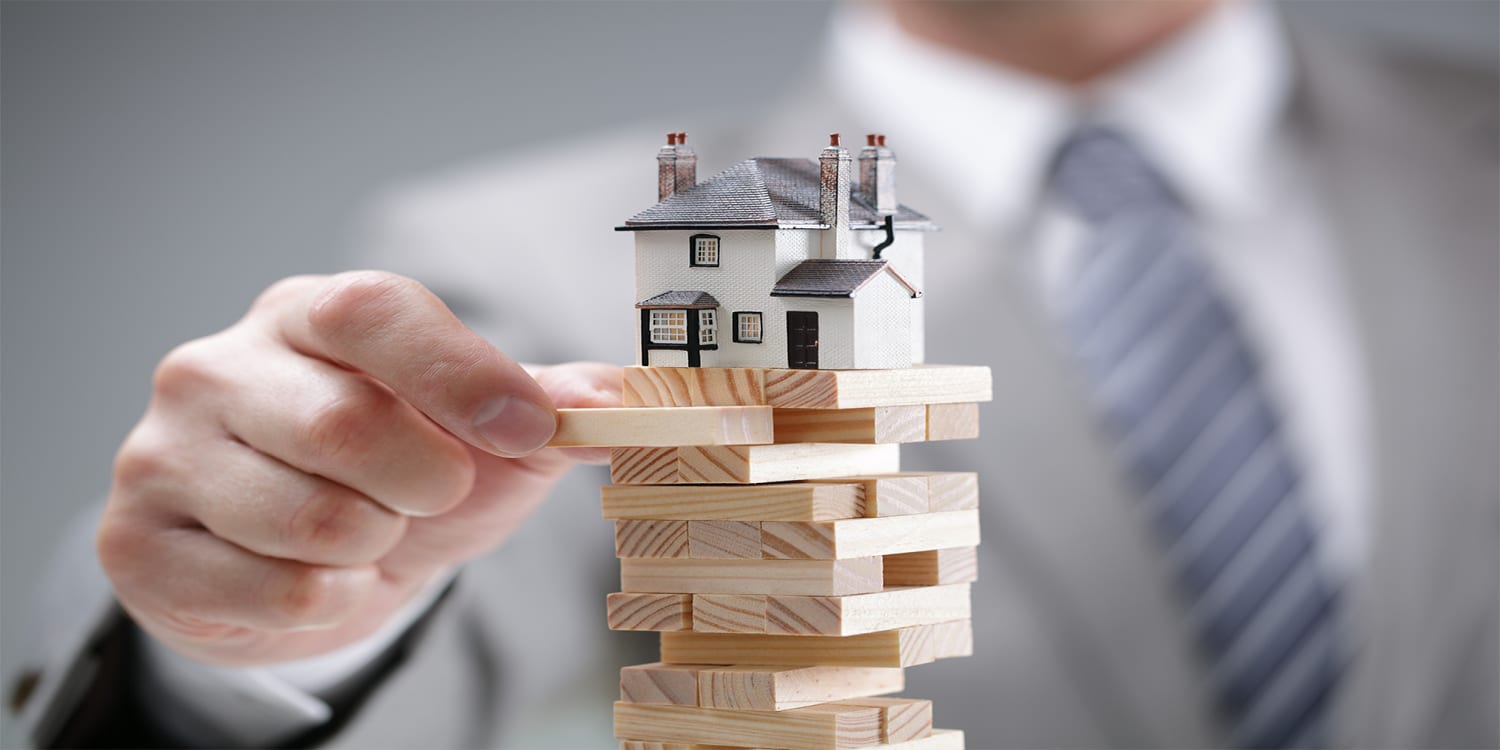 House on top of tower of blocks - real estate analytics concept